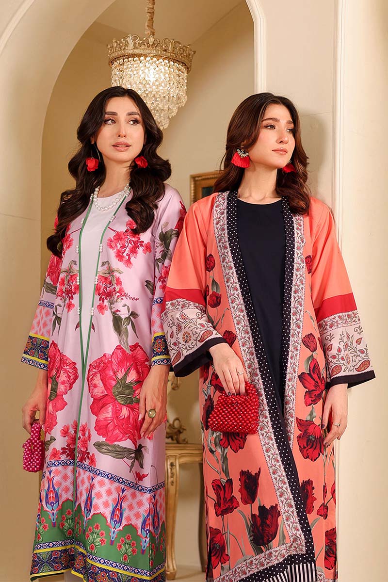 Two women wearing floral patterned outfits in a decorative interior setting.